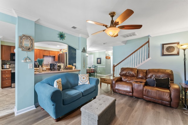 living room featuring crown molding, ceiling fan, and hardwood / wood-style flooring