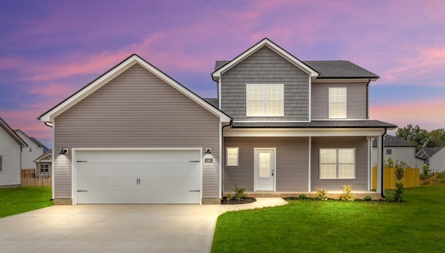 view of front facade featuring a yard and a garage