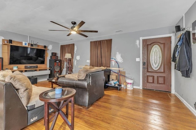 living room featuring light hardwood / wood-style floors and ceiling fan