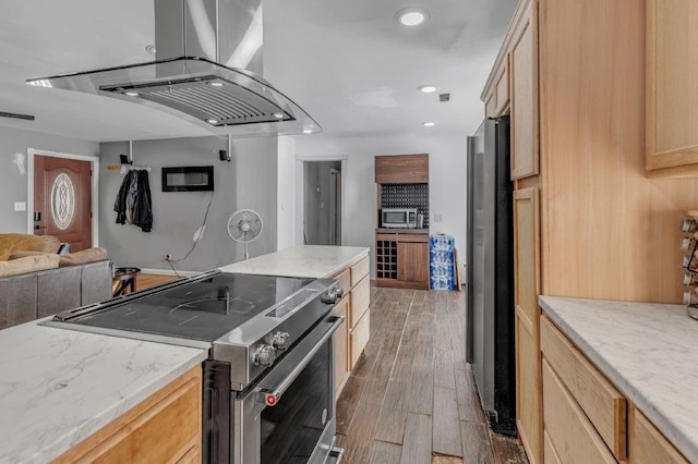 kitchen with light brown cabinets, dark wood-type flooring, island range hood, light stone counters, and stainless steel appliances