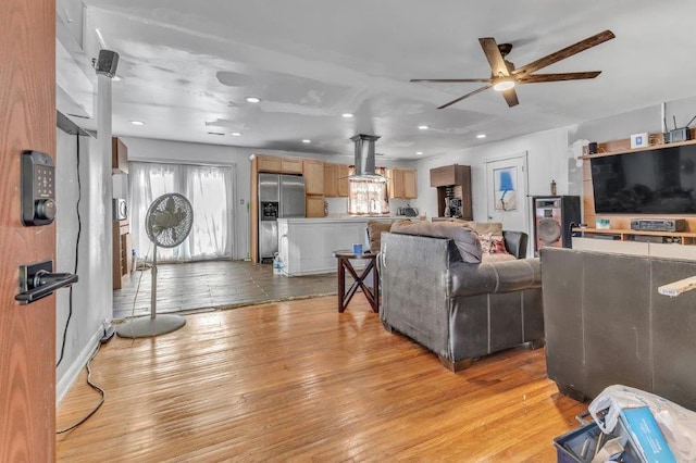 living room with light wood-type flooring and ceiling fan