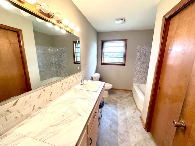 bathroom featuring tasteful backsplash, vanity, and toilet