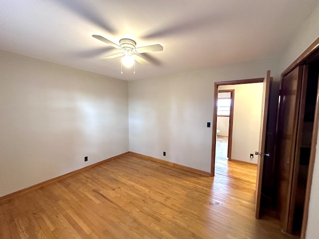 empty room featuring ceiling fan and light hardwood / wood-style floors