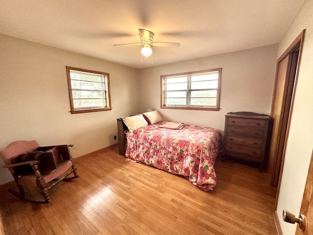 bedroom with light hardwood / wood-style flooring and ceiling fan