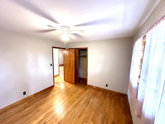 unfurnished bedroom featuring ceiling fan and light wood-type flooring