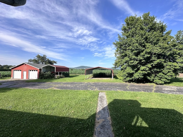 view of yard with an outdoor structure and a carport