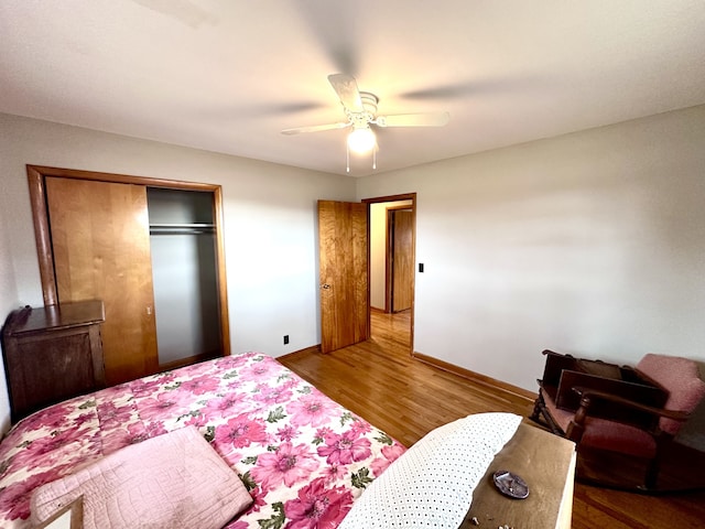 bedroom featuring hardwood / wood-style floors, a closet, and ceiling fan