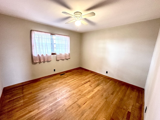 unfurnished room featuring ceiling fan and hardwood / wood-style flooring