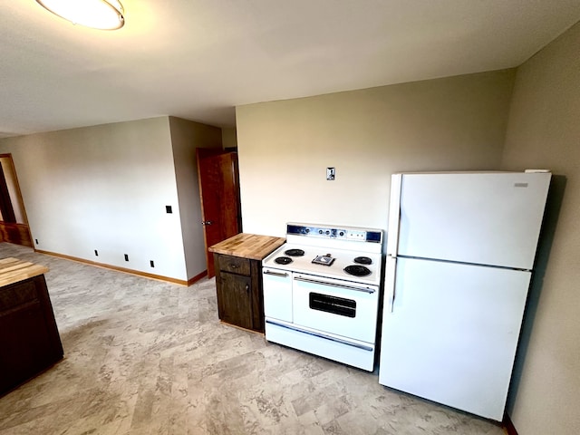 kitchen with wood counters and white appliances