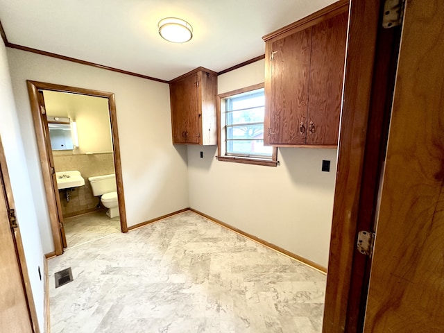 laundry room with ornamental molding and sink