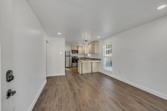 unfurnished living room with light wood-type flooring and sink