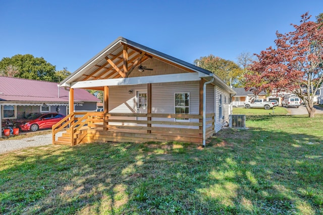 bungalow-style house with cooling unit, covered porch, and a front lawn