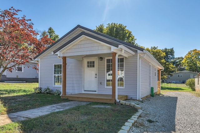 bungalow-style house with covered porch and a front yard