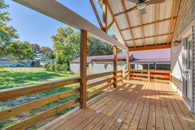 wooden terrace featuring ceiling fan and a lawn