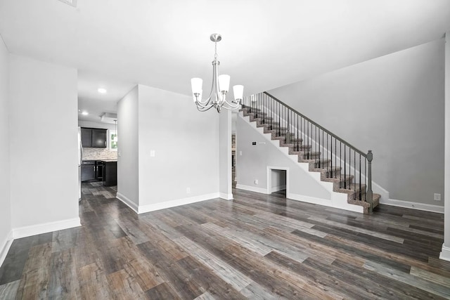 interior space with dark hardwood / wood-style floors and a notable chandelier