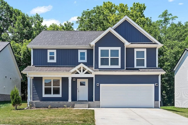 craftsman inspired home featuring a garage and a front lawn