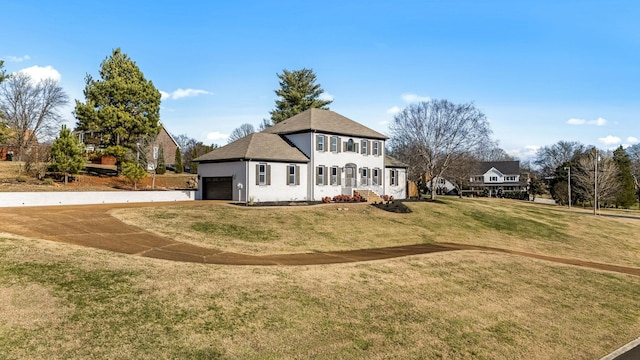 exterior space featuring a garage and a front lawn