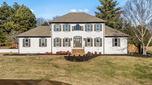 colonial-style house with a front yard