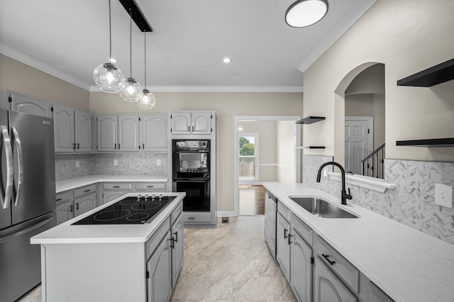 kitchen with sink, a center island, gray cabinets, black appliances, and ornamental molding