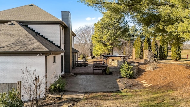 view of home's exterior featuring a patio area and a wooden deck