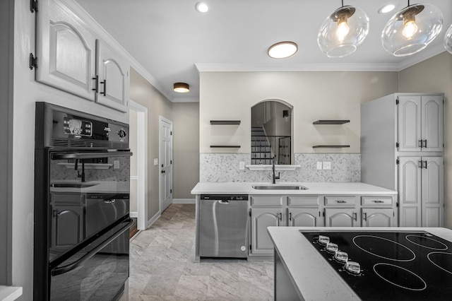 kitchen with black appliances, sink, ornamental molding, tasteful backsplash, and decorative light fixtures