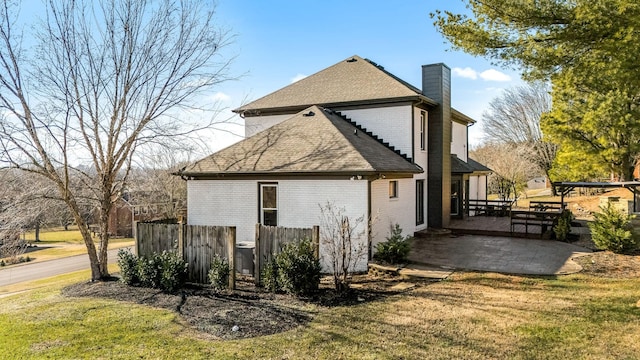 view of side of property with a lawn and a patio area