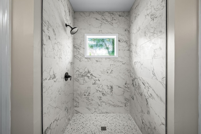 bathroom with a tile shower