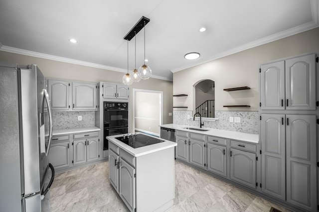 kitchen with black appliances, sink, hanging light fixtures, gray cabinets, and a kitchen island