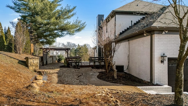 view of side of property featuring central AC