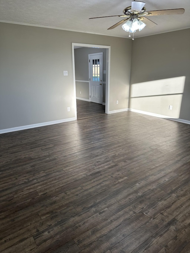 spare room with a textured ceiling, ceiling fan, dark hardwood / wood-style floors, and ornamental molding