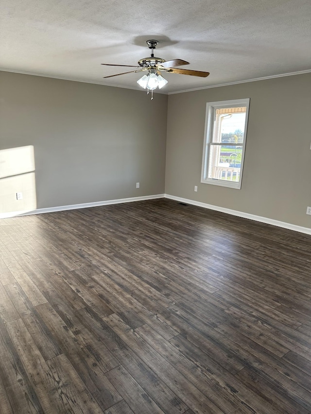 empty room featuring a textured ceiling, dark hardwood / wood-style flooring, and crown molding