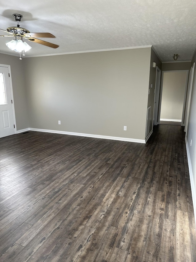 empty room featuring a textured ceiling, dark hardwood / wood-style flooring, ceiling fan, and ornamental molding