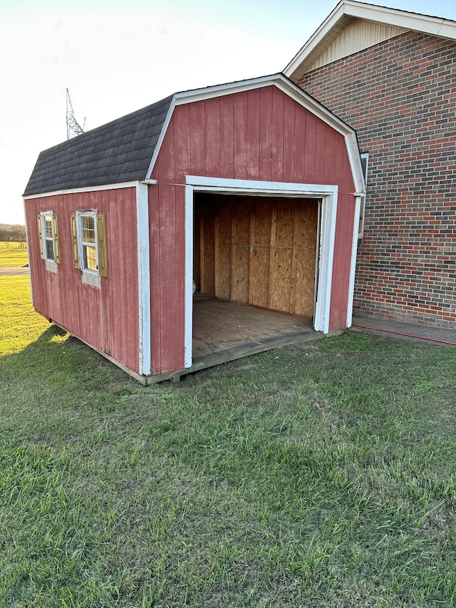 view of outbuilding featuring a yard