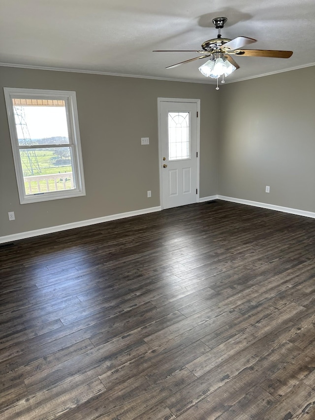 interior space with ceiling fan, dark hardwood / wood-style floors, and ornamental molding