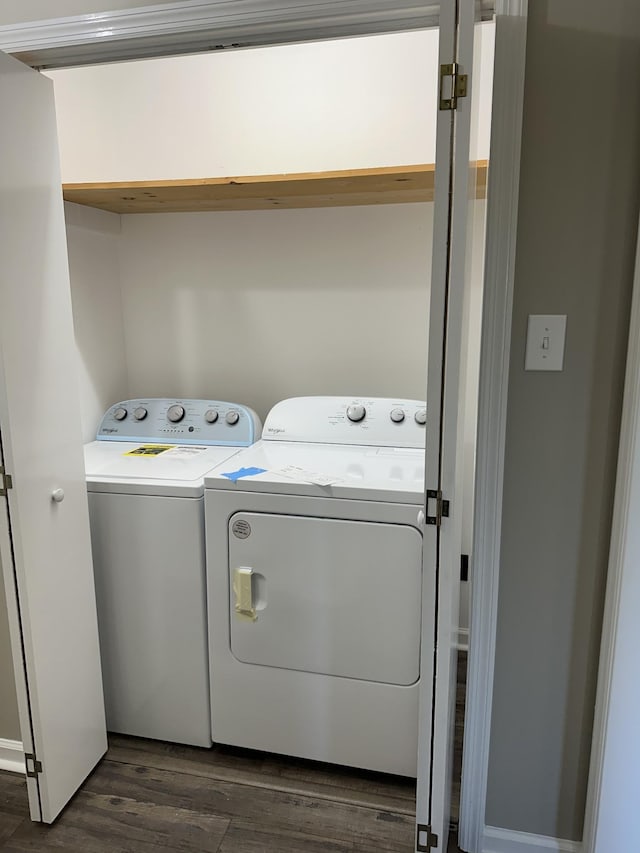 laundry area featuring separate washer and dryer and dark hardwood / wood-style floors