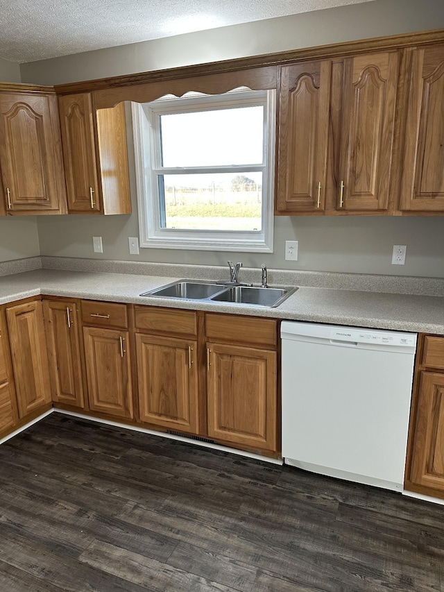 kitchen featuring a textured ceiling, dishwasher, dark hardwood / wood-style floors, and sink