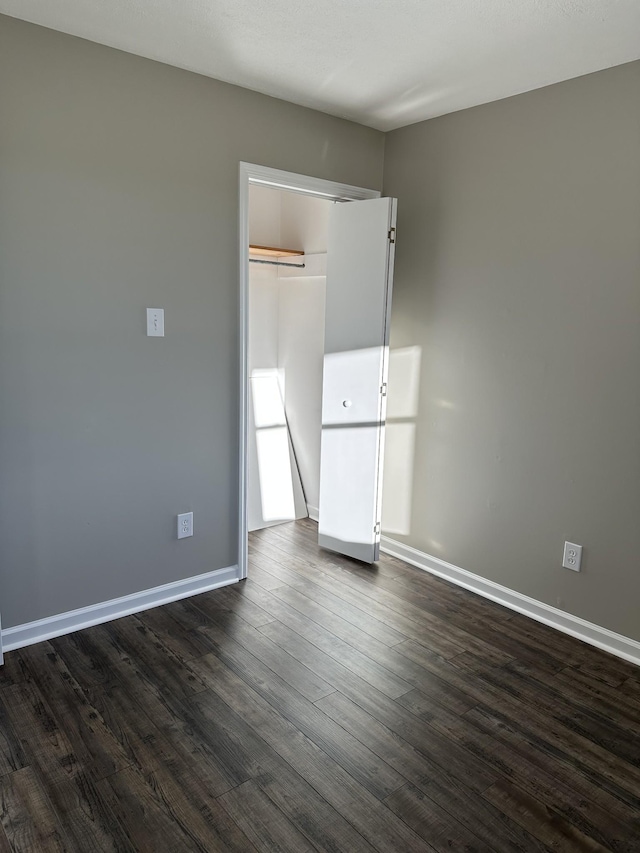 unfurnished room featuring dark hardwood / wood-style flooring