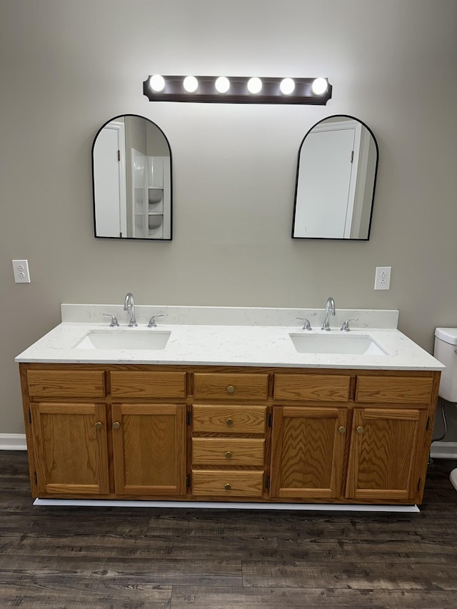 bathroom featuring vanity, wood-type flooring, and toilet