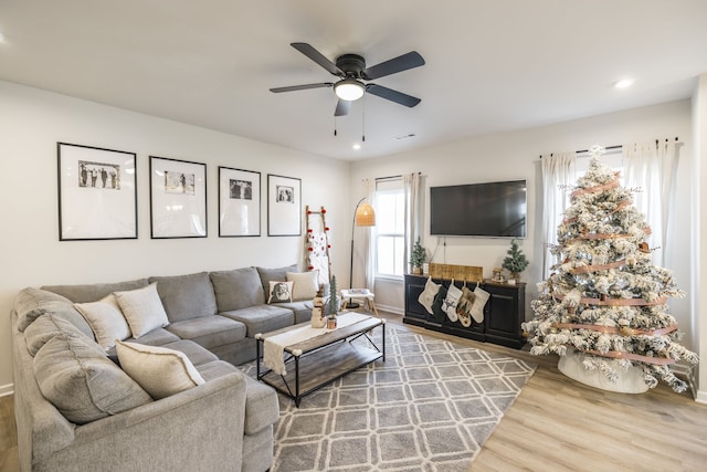 living room featuring hardwood / wood-style flooring and ceiling fan