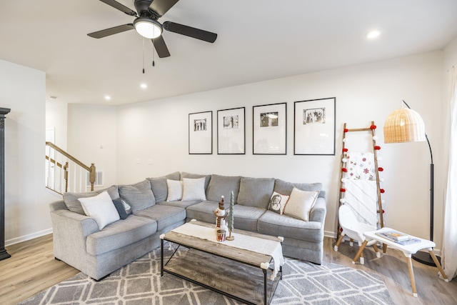 living room featuring ceiling fan and light wood-type flooring