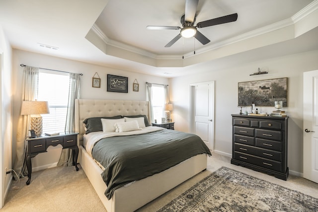 bedroom featuring a raised ceiling, ceiling fan, light colored carpet, and crown molding