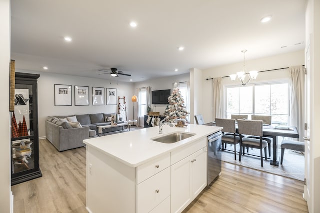 kitchen featuring dishwasher, sink, light hardwood / wood-style flooring, a center island with sink, and white cabinets