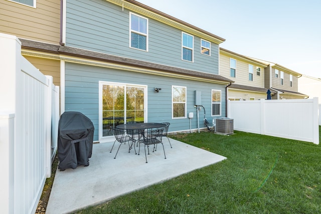 rear view of property with a patio, a lawn, and central air condition unit