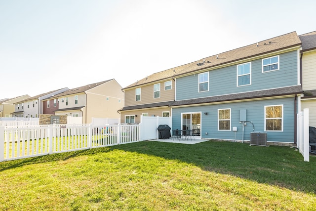 rear view of house with a lawn, a patio, and central AC unit