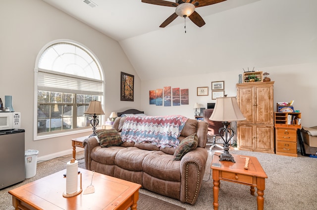 carpeted living room with ceiling fan and vaulted ceiling