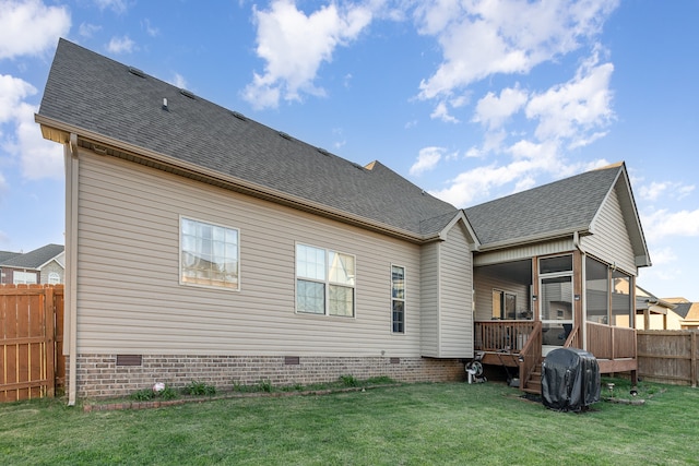 back of house with a sunroom and a yard