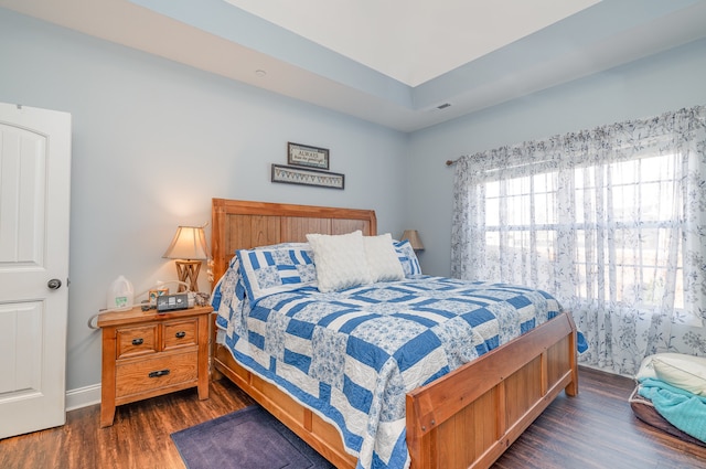 bedroom with dark wood-type flooring