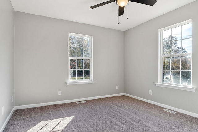 spare room with ceiling fan and carpet