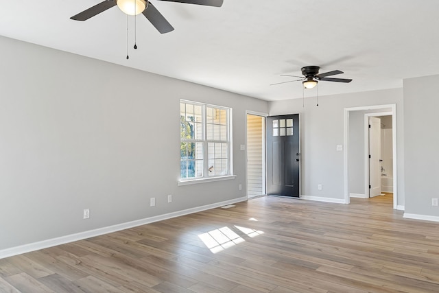 empty room featuring ceiling fan and light wood-type flooring