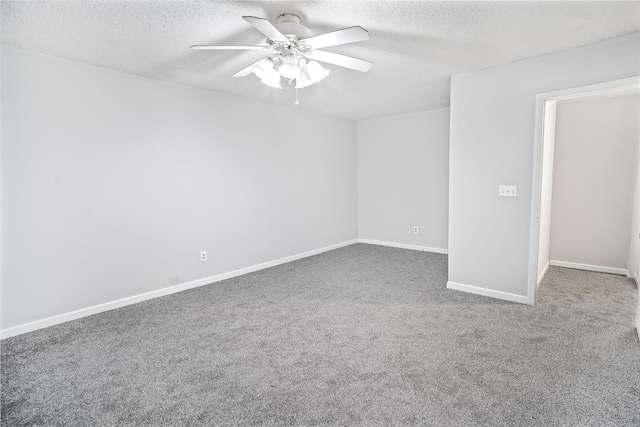 carpeted spare room with a textured ceiling and ceiling fan